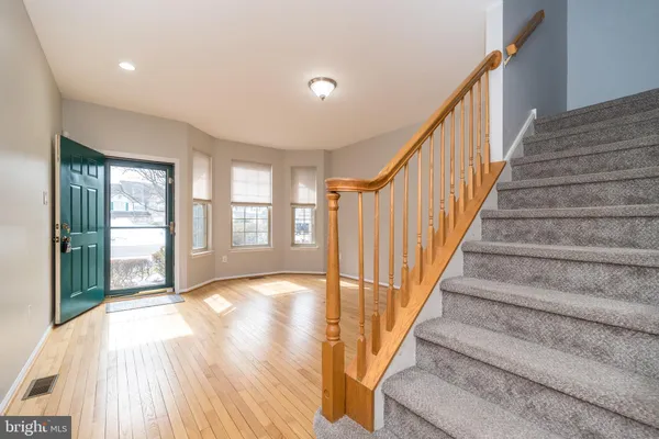 a view of an entryway with wooden floor and door