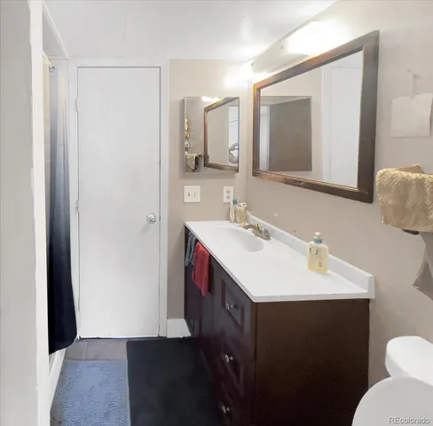 a bathroom with a sink vanity and a mirror