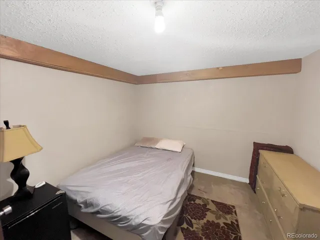 a bedroom with a bed and a dresser in it