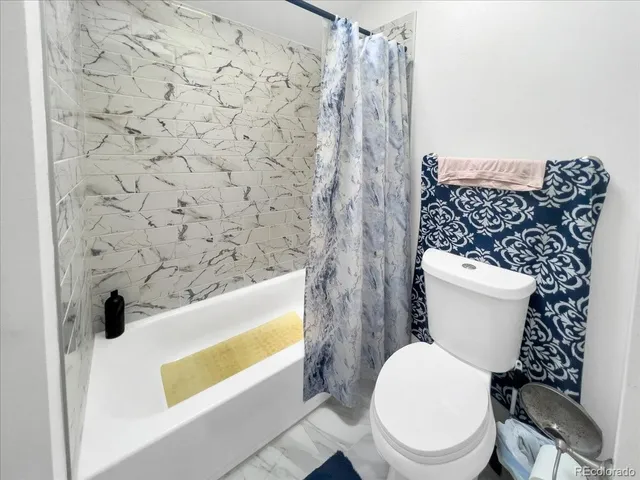 a white toilet sitting next to a bathroom sink