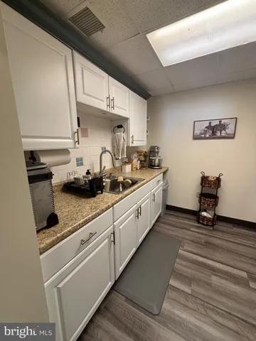 a kitchen with stainless steel appliances a sink stove and cabinets