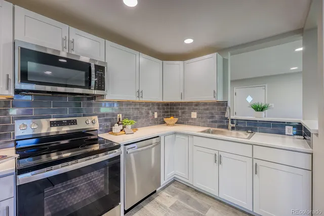 a kitchen with a sink stove and microwave