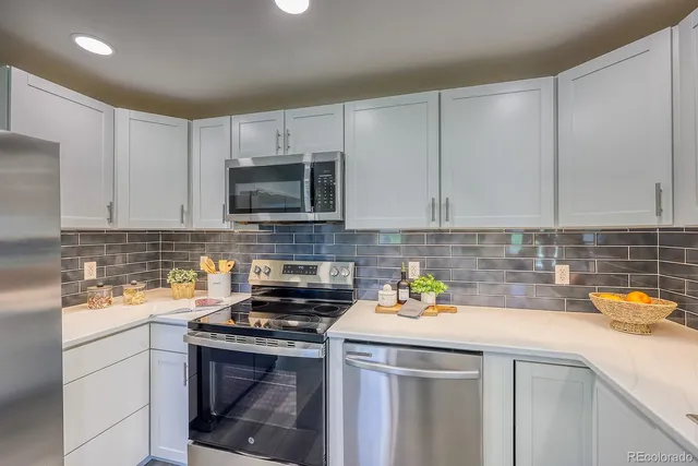 a kitchen with a sink and a stove top oven