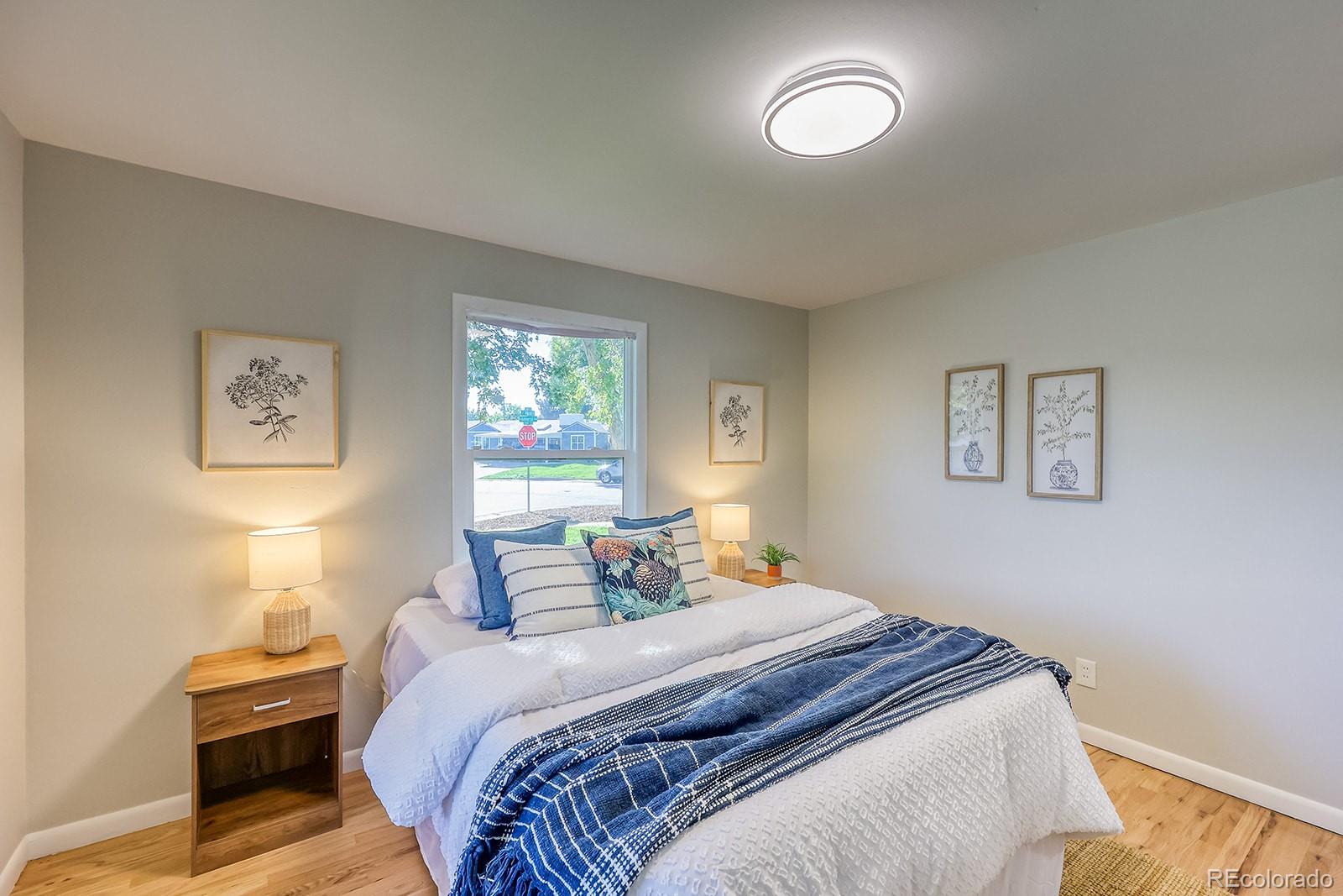 2785 South Hazel Court Denver, CO 80236 - Photo 16 of 38 a bedroom with a bed and a window