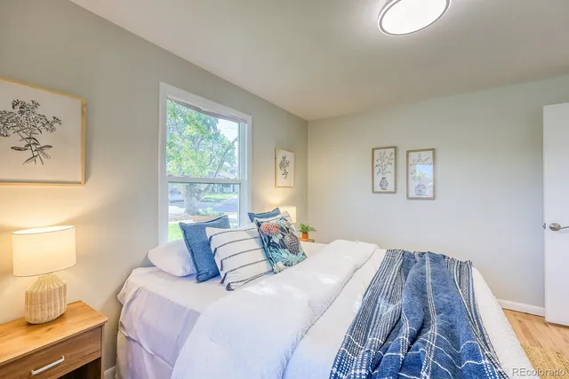 a bedroom with a bed and wooden floor