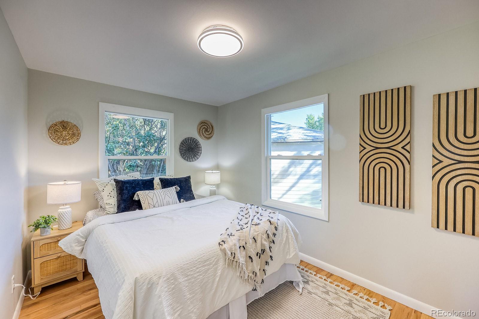 2785 South Hazel Court Denver, CO 80236 - Photo 19 of 38 a bedroom with a bed and a window