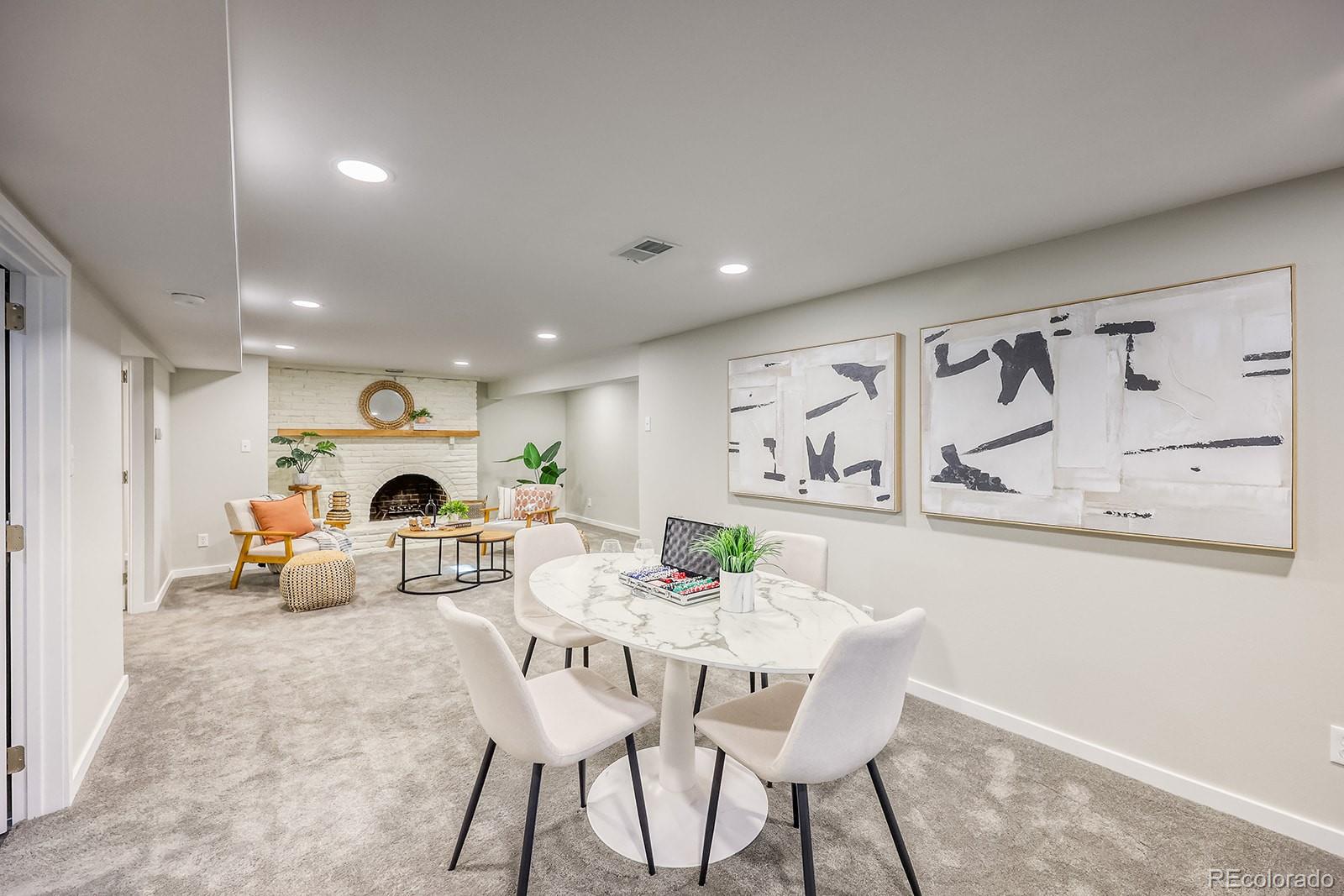 2785 South Hazel Court Denver, CO 80236 - Photo 21 of 38 a view of a dining room with furniture a potted plant and wooden floor