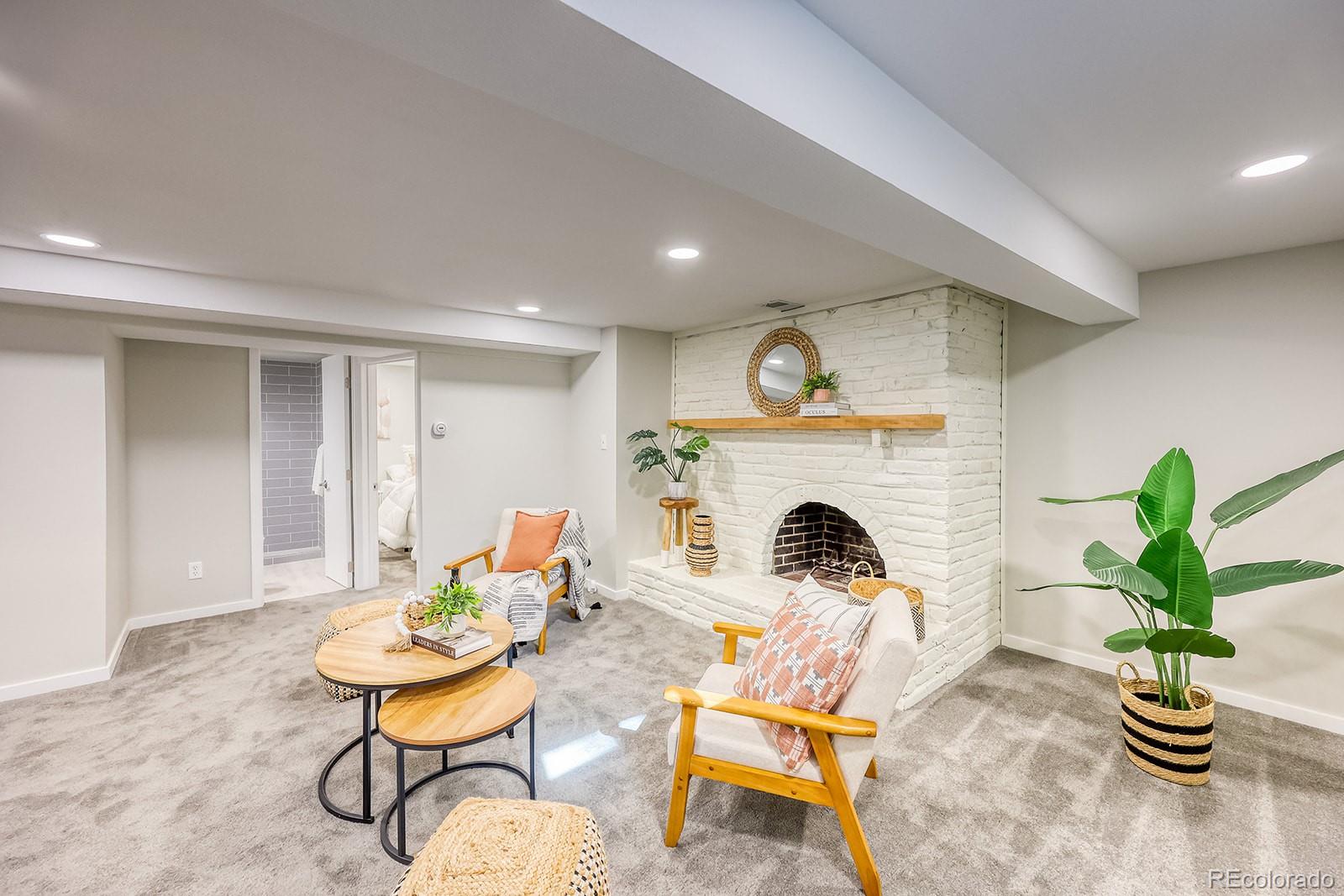 2785 South Hazel Court Denver, CO 80236 - Photo 25 of 38 a living room with furniture and a fireplace