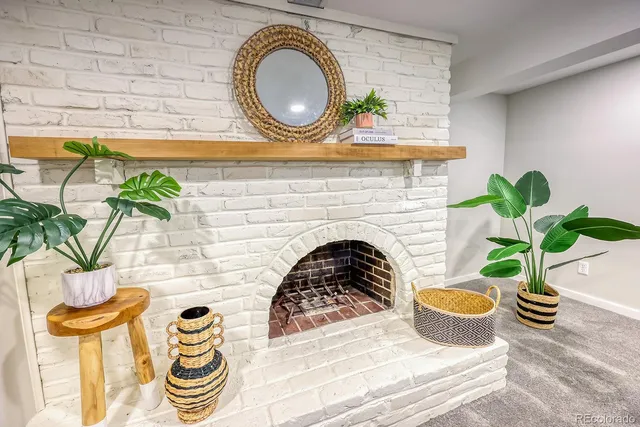 a living room with a couch and a potted plant
