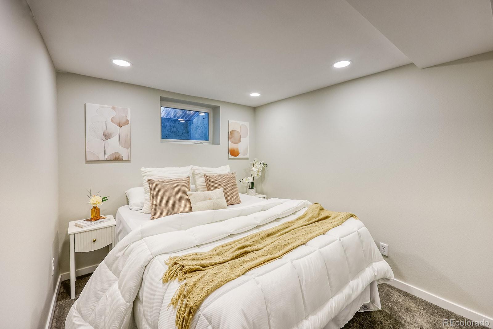 2785 South Hazel Court Denver, CO 80236 - Photo 29 of 38 a bedroom with a bed and a window