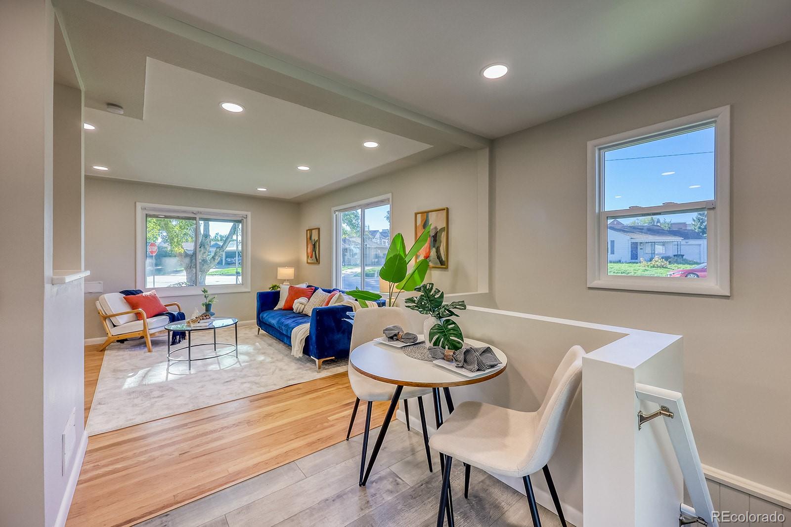 2785 South Hazel Court Denver, CO 80236 - Photo 3 of 38 a living room with furniture kitchen and a table
