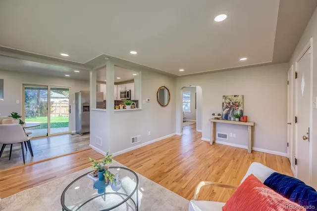 a living room with furniture and wooden floor