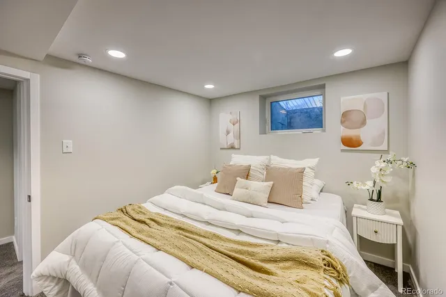 a bedroom with a bed and lamp