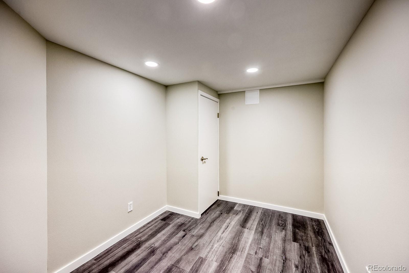 2785 South Hazel Court Denver, CO 80236 - Photo 32 of 38 a view of room with wooden floor