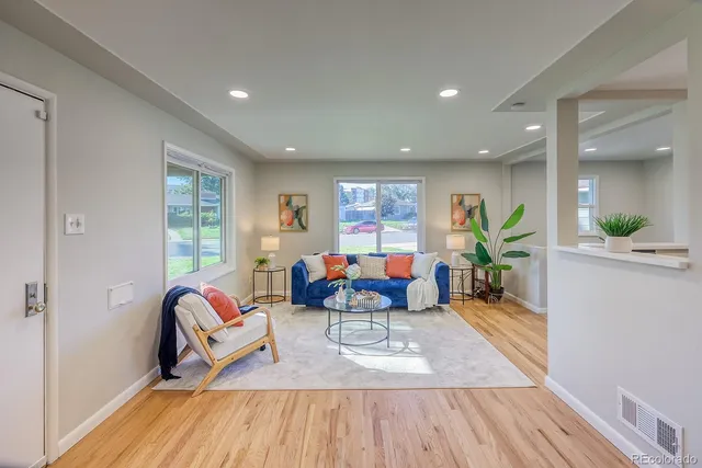 a living room with furniture and wooden floor