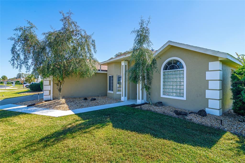 5334 Northwest 19th Place Ocala, FL 34482 - Photo 2 of 42 a front view of a house with garden