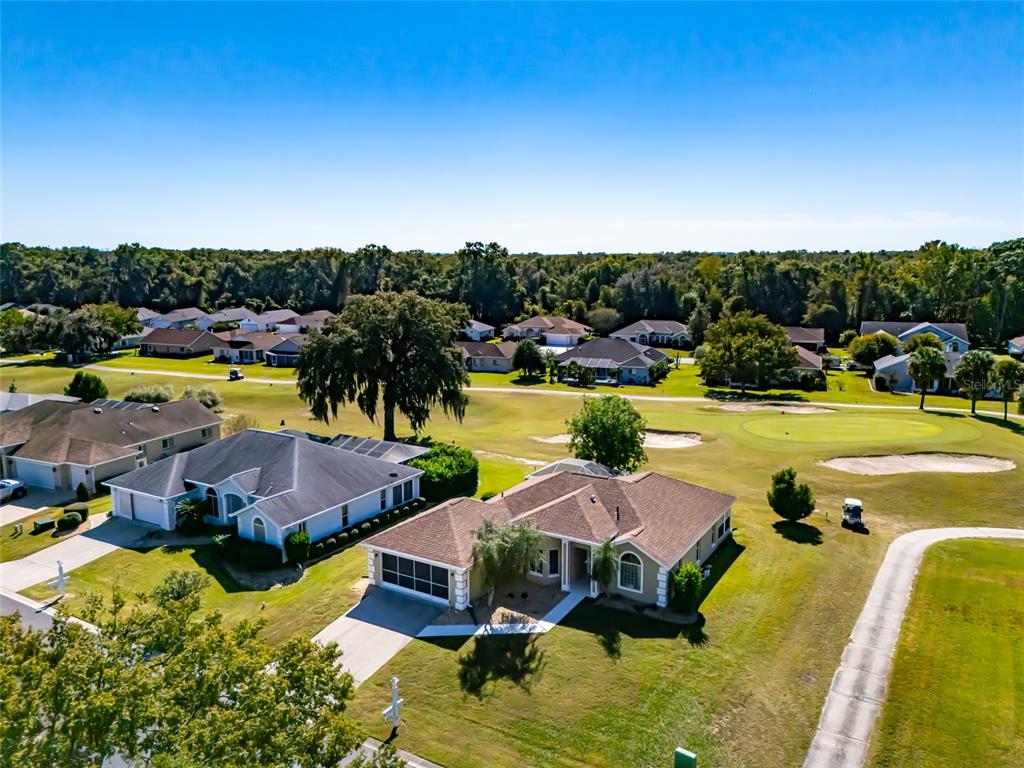 5334 Northwest 19th Place Ocala, FL 34482 - Photo 32 of 42 a view of a swimming pool with lawn chairs under an umbrella