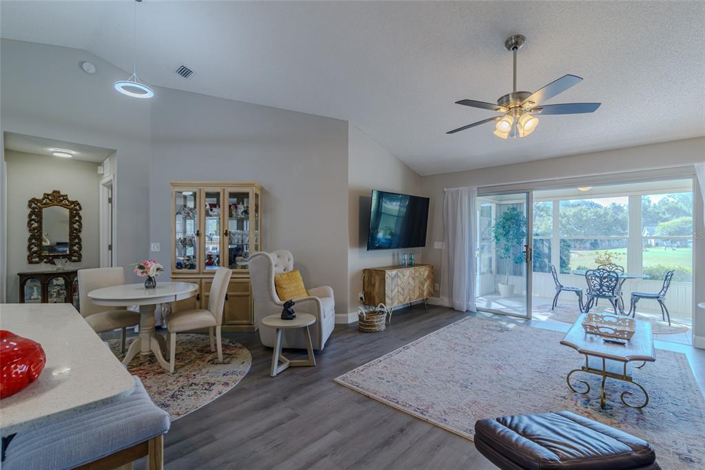 5334 Northwest 19th Place Ocala, FL 34482 - Photo 6 of 42 a living room with furniture a flat screen tv and a large window