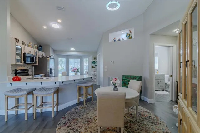 a view of a dining room with furniture and a kitchen