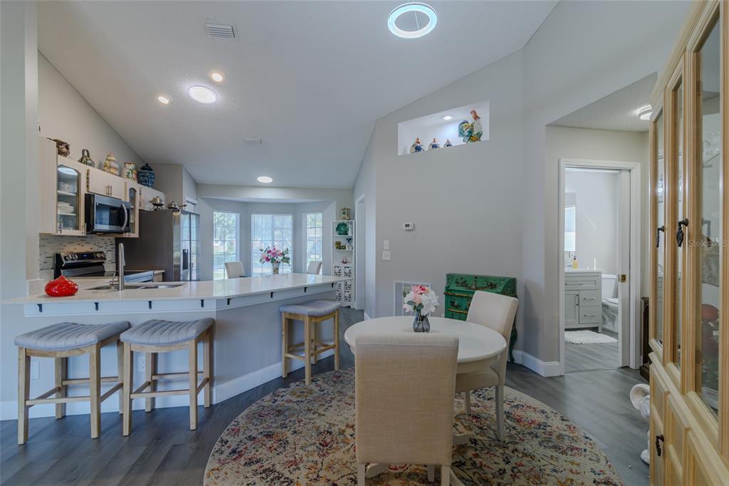 5334 Northwest 19th Place Ocala, FL 34482 - Photo 7 of 42 a view of a dining room with furniture and a kitchen