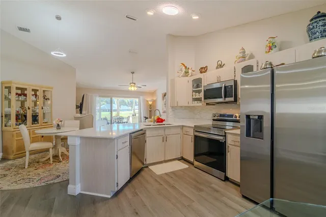 a kitchen with a sink cabinets and stainless steel appliances