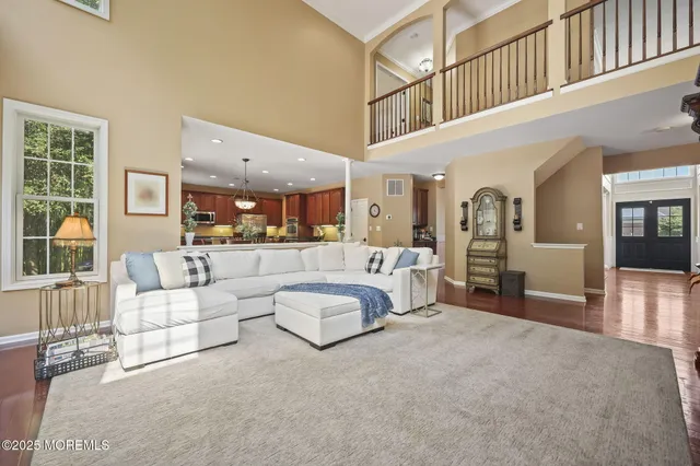 a kitchen with granite countertop stainless steel appliances a sink a stove top oven a counter space and cabinets