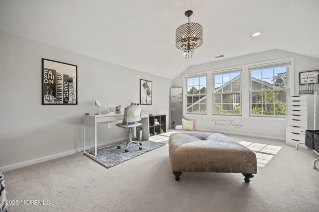 a view of backyard with seating space and wooden fence