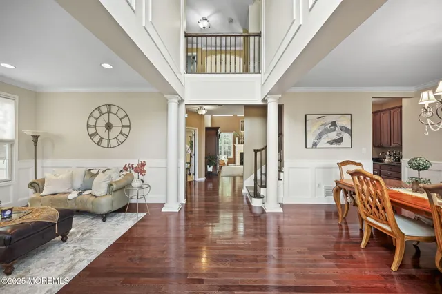 a living room with furniture a fireplace and a floor to ceiling window