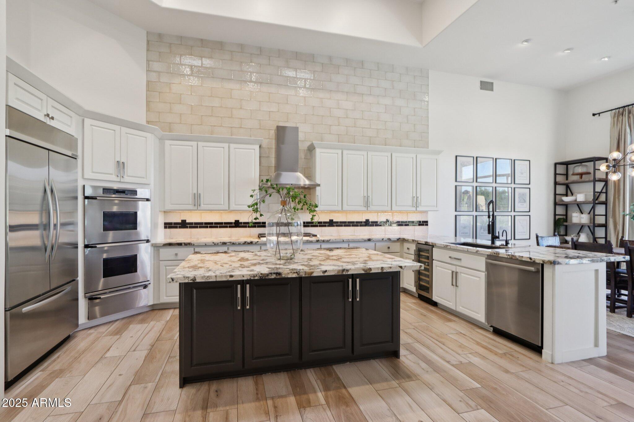 30600 North Pima Road, Unit 49 Scottsdale, AZ 85266 - Photo 12 of 53 a kitchen with kitchen island granite countertop wooden cabinets and stainless steel appliances