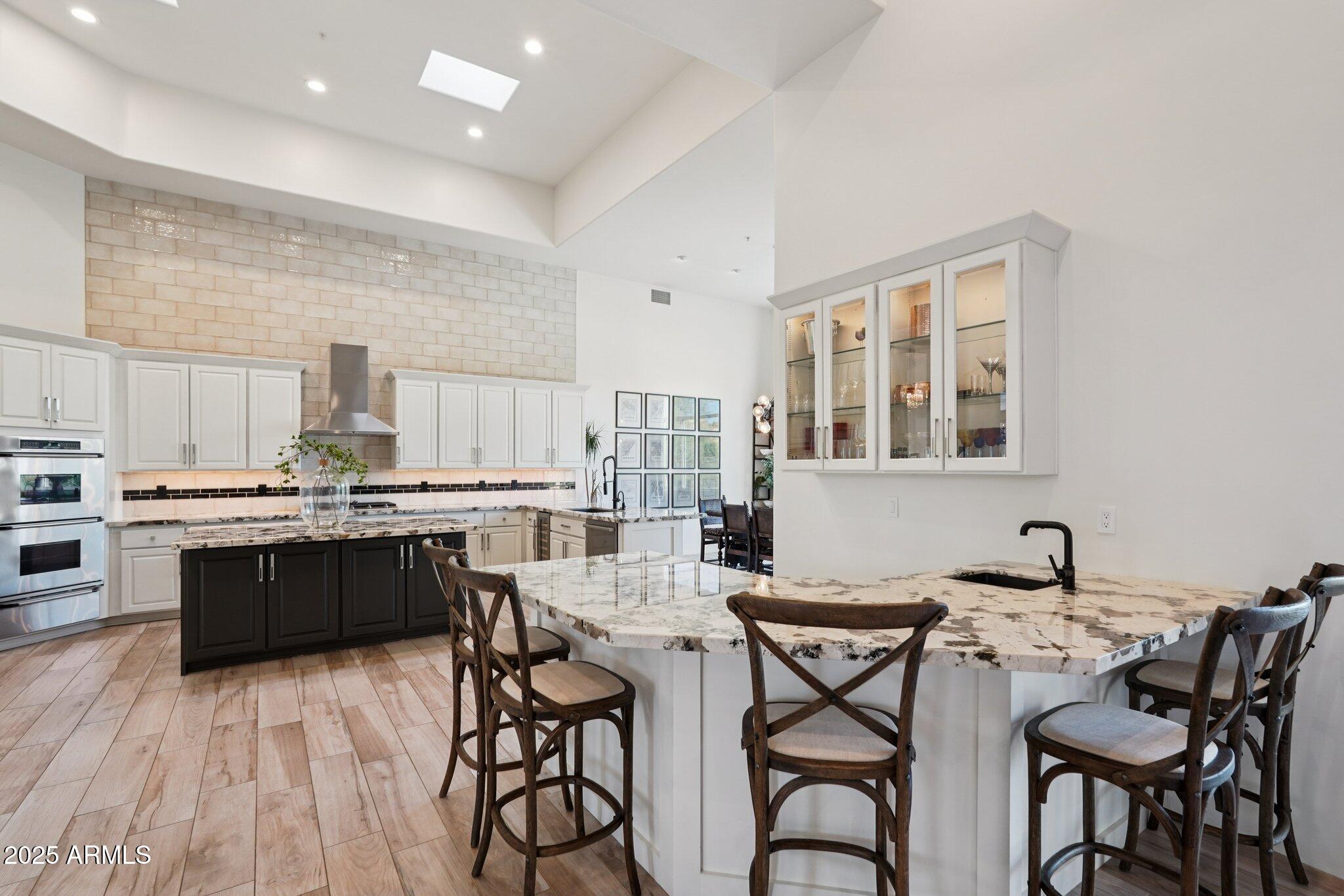 30600 North Pima Road, Unit 49 Scottsdale, AZ 85266 - Photo 15 of 53 a kitchen with a table chairs stove and cabinets