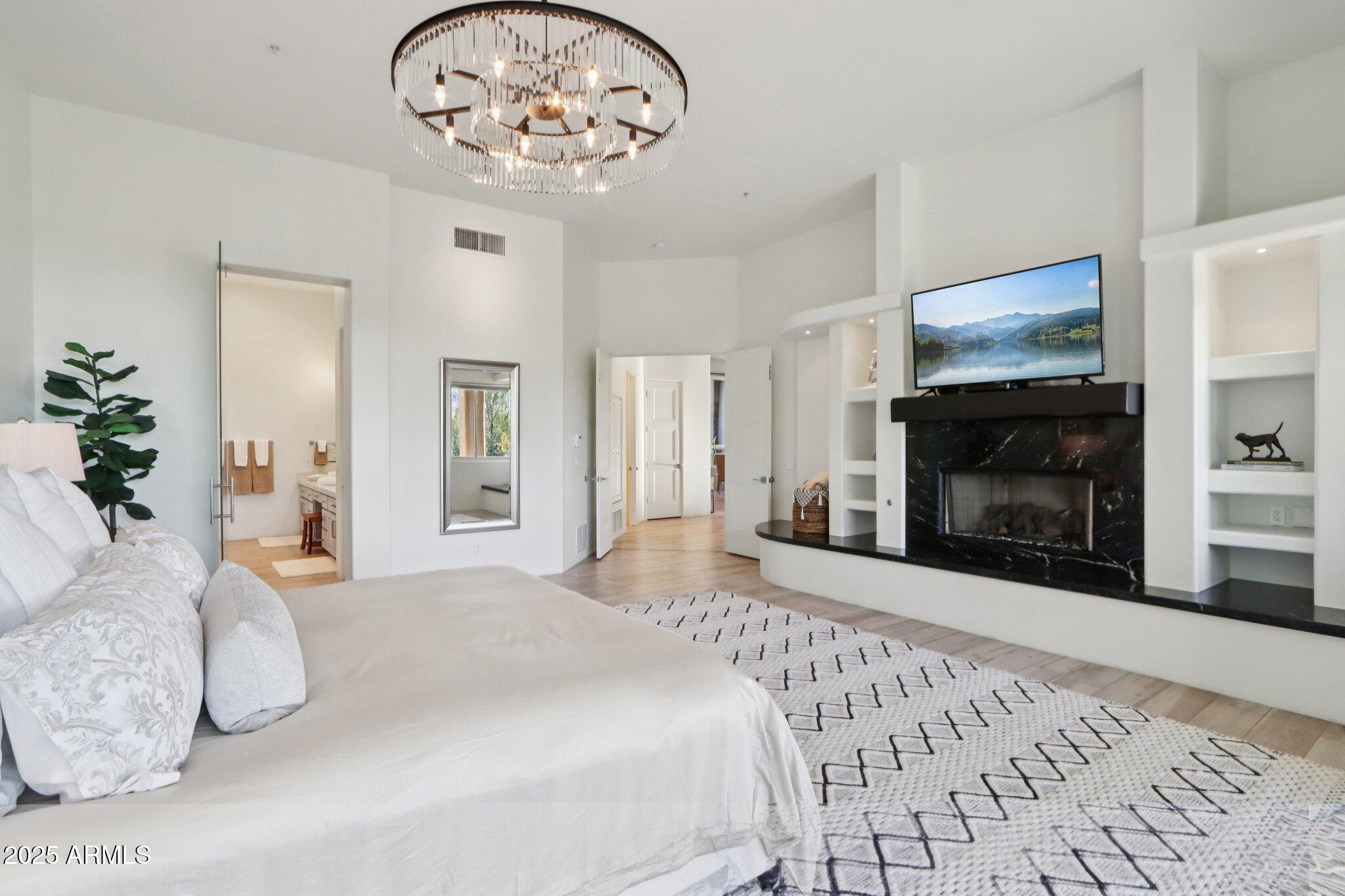 30600 North Pima Road, Unit 49 Scottsdale, AZ 85266 - Photo 18 of 53 a bedroom with a bed and a fireplace