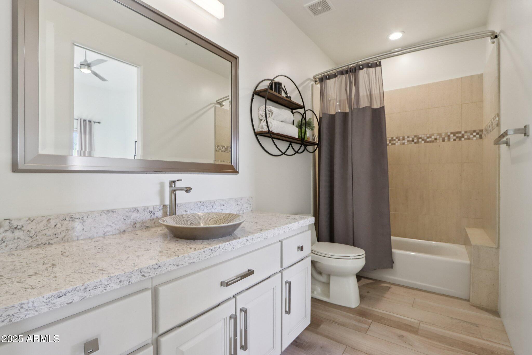 30600 North Pima Road, Unit 49 Scottsdale, AZ 85266 - Photo 29 of 53 a bathroom with a granite countertop sink a toilet and a mirror