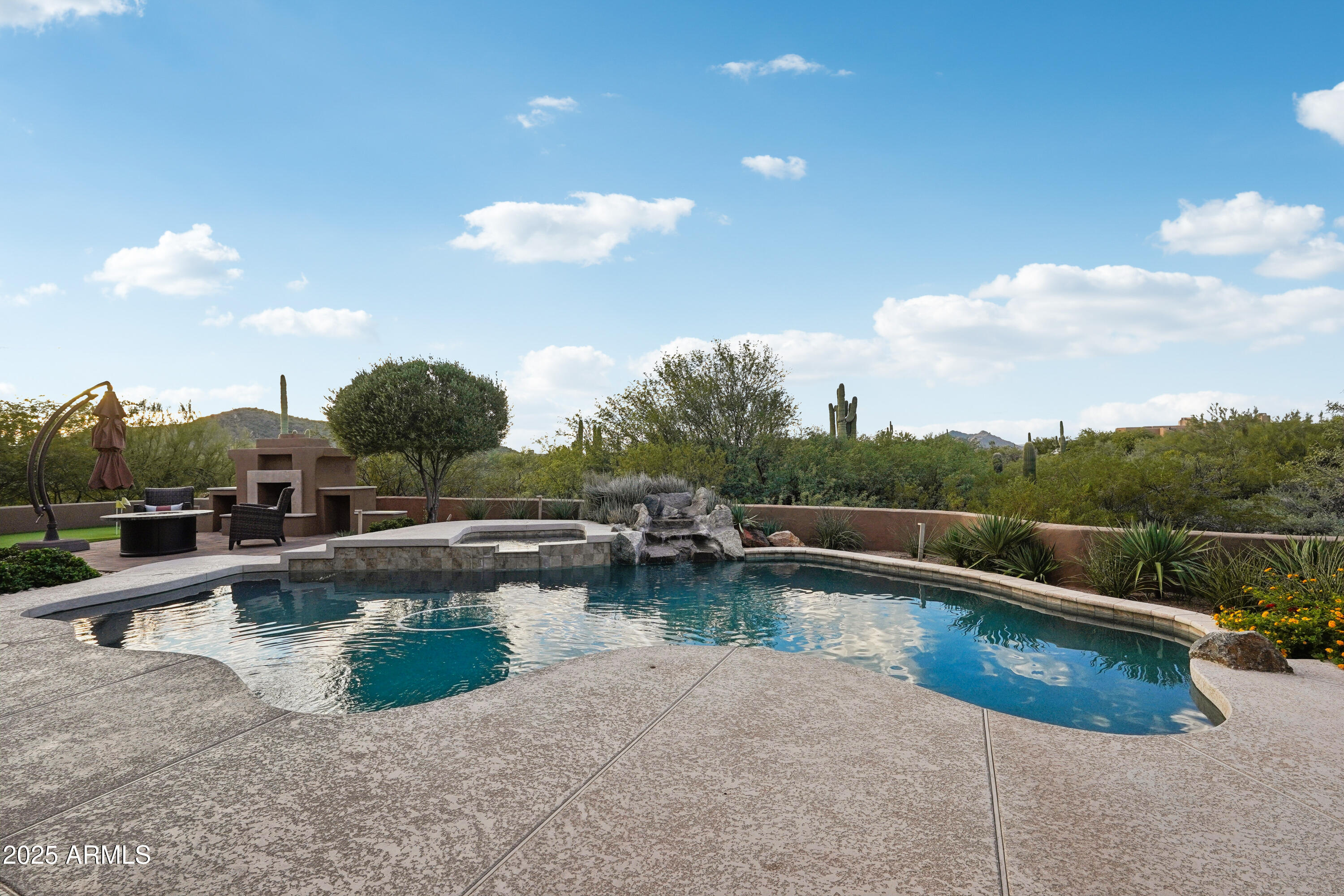 30600 North Pima Road, Unit 49 Scottsdale, AZ 85266 - Photo 35 of 53 a view of a swimming pool with a lawn chairs