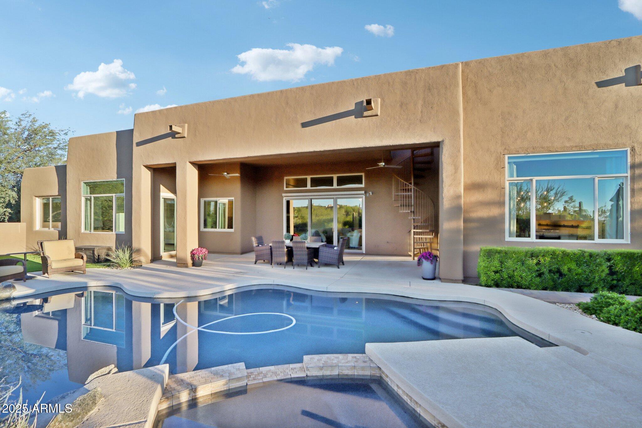 30600 North Pima Road, Unit 49 Scottsdale, AZ 85266 - Photo 36 of 53 a view of a patio with couches table and chairs with wooden floor and fence