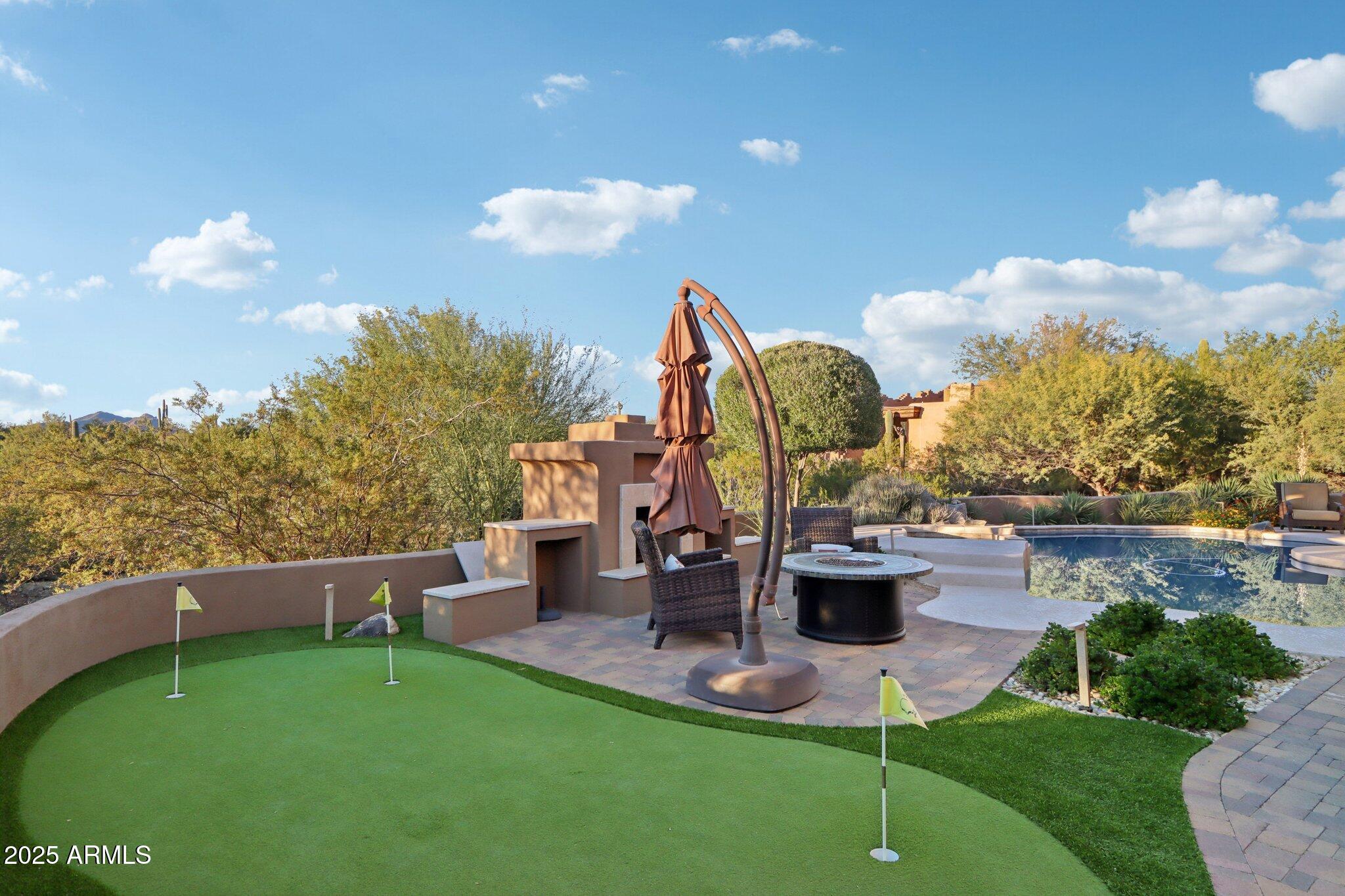 30600 North Pima Road, Unit 49 Scottsdale, AZ 85266 - Photo 37 of 53 a view of a garden with a slide and large trees