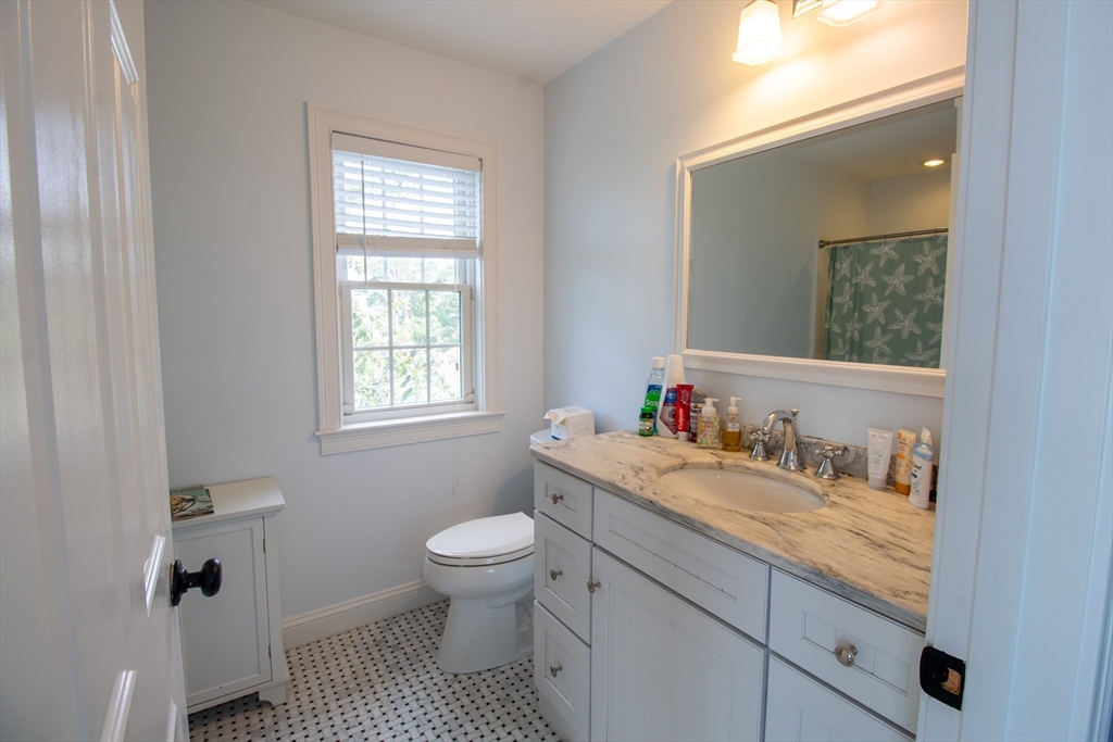 117 River Street Scituate, MA 02050 - Photo 14 of 23 a bathroom with a granite countertop toilet sink and mirror