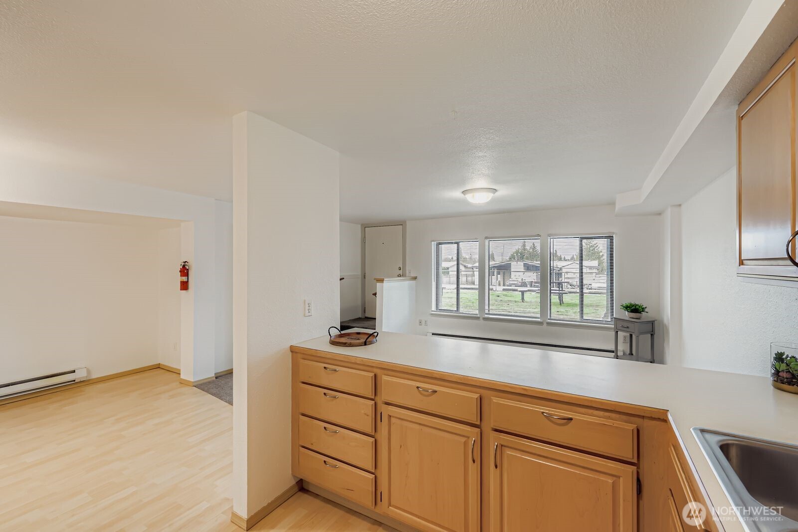 2120 Highland Avenue, Unit 104 Everett, WA 98201 - Photo 11 of 22 a kitchen with granite countertop cabinets stainless steel appliances a sink and a window