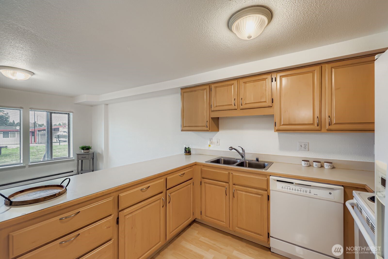 2120 Highland Avenue, Unit 104 Everett, WA 98201 - Photo 9 of 22 a kitchen with sink cabinets and window