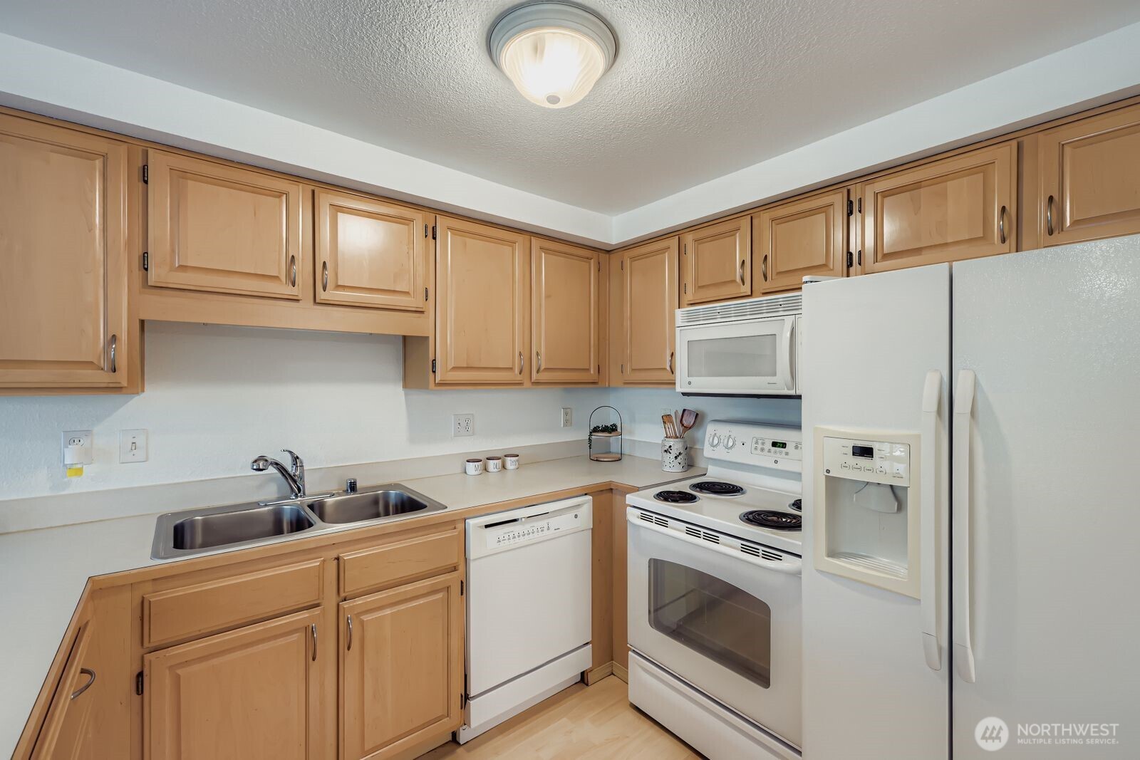2120 Highland Avenue, Unit 104 Everett, WA 98201 - Photo 10 of 22 a kitchen with white cabinets and white appliances