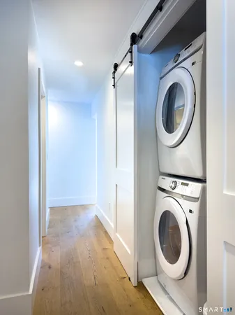 a view of a hallway with washer and dryer