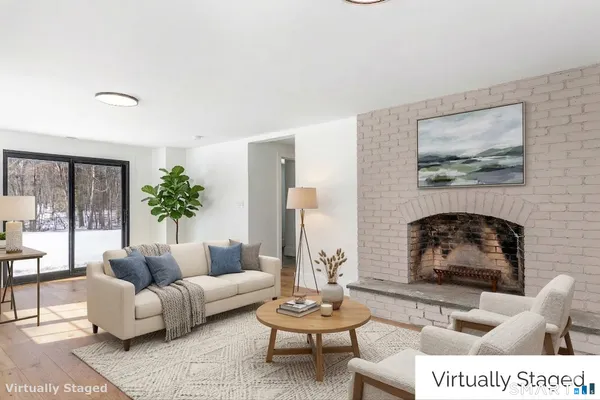 a living room with furniture and a potted plant