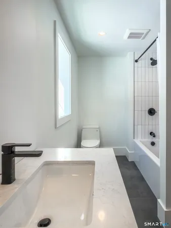 a bathroom with a bathtub and shower
