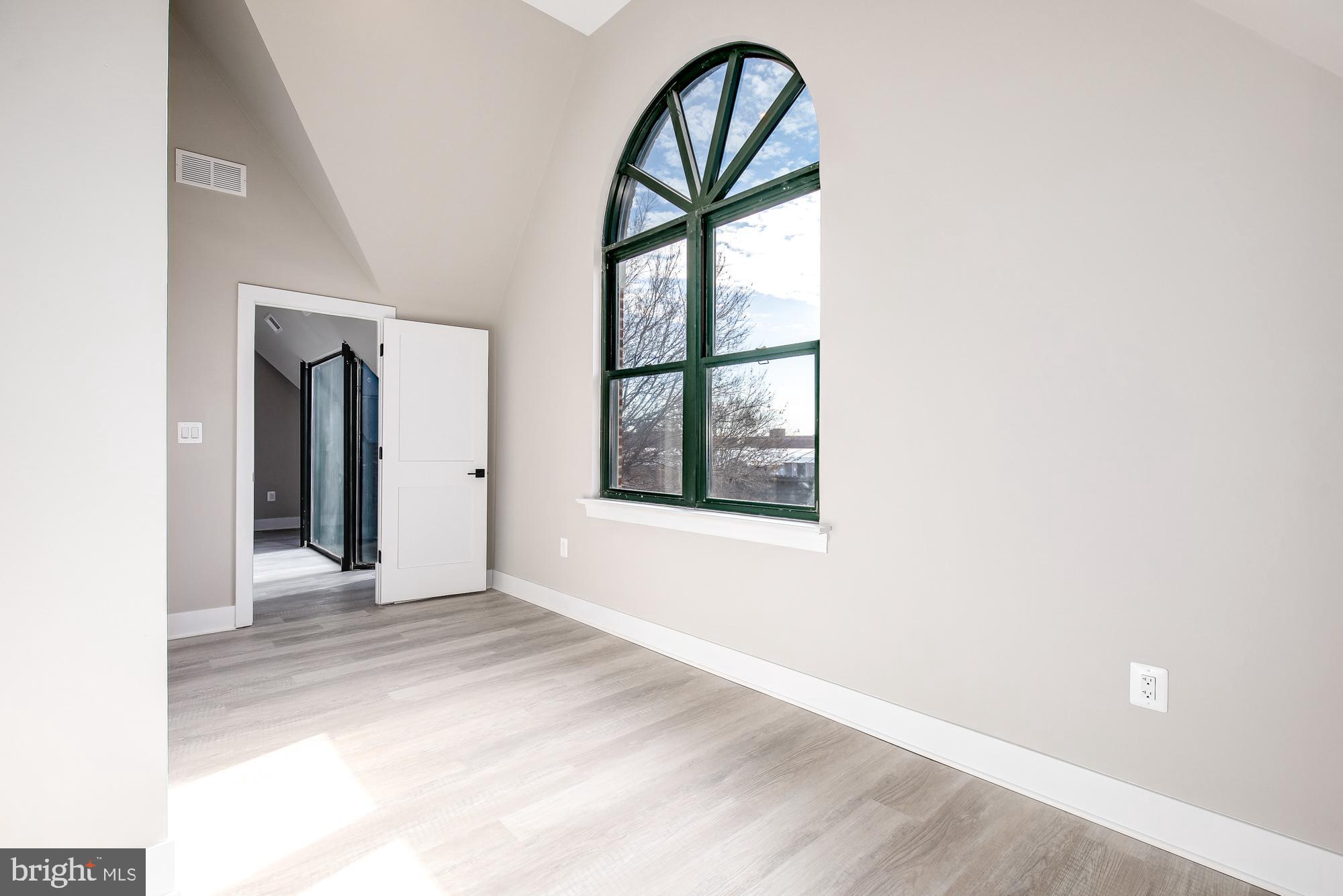 3325 M Street Northwest, Unit TWO Washington, DC 20007 - Photo 11 of 33 a view of an empty room with glass door and wooden floor