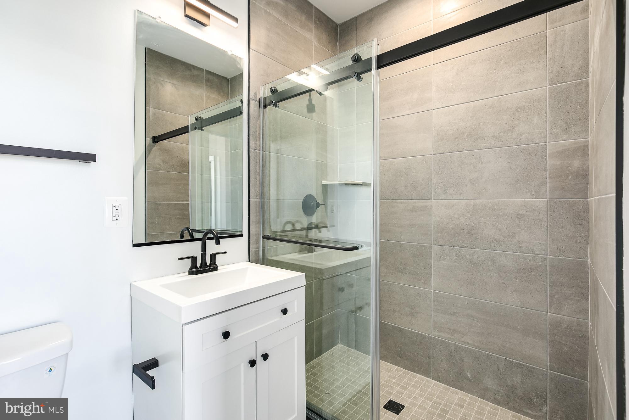 3325 M Street Northwest, Unit TWO Washington, DC 20007 - Photo 12 of 33 a bathroom with a shower sink and mirror