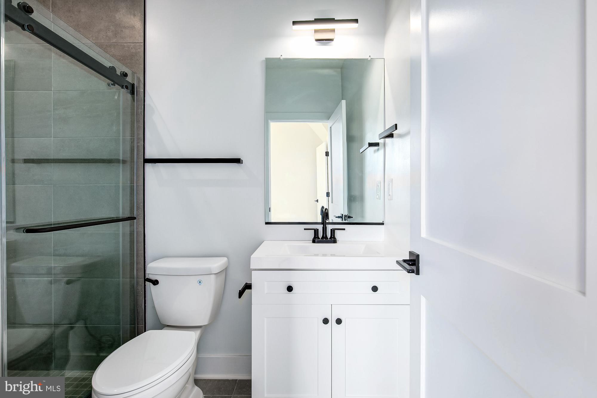 3325 M Street Northwest, Unit TWO Washington, DC 20007 - Photo 18 of 33 a bathroom with a sink toilet and mirror