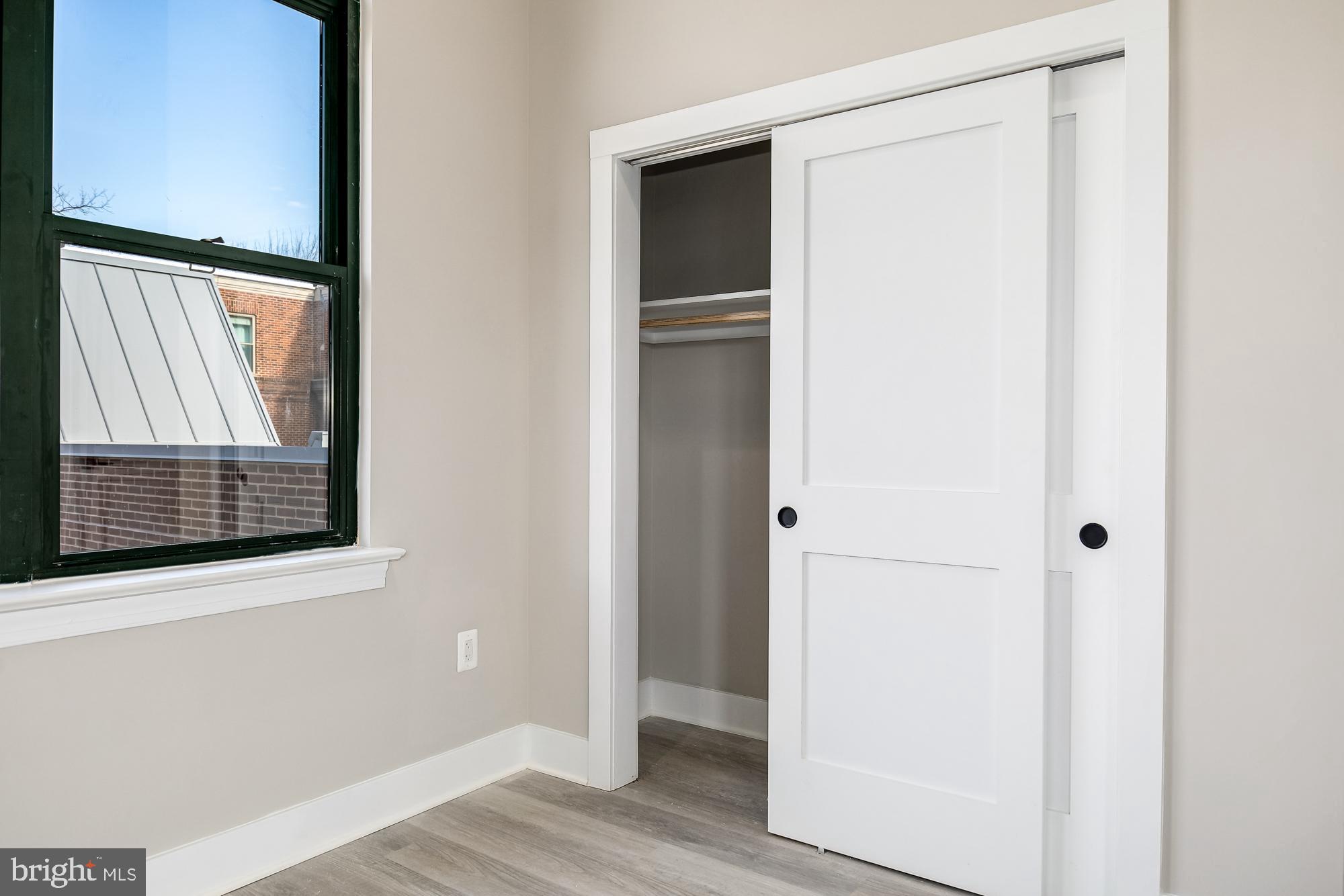 3325 M Street Northwest, Unit TWO Washington, DC 20007 - Photo 20 of 33 a view of an empty room with wooden floor and a window