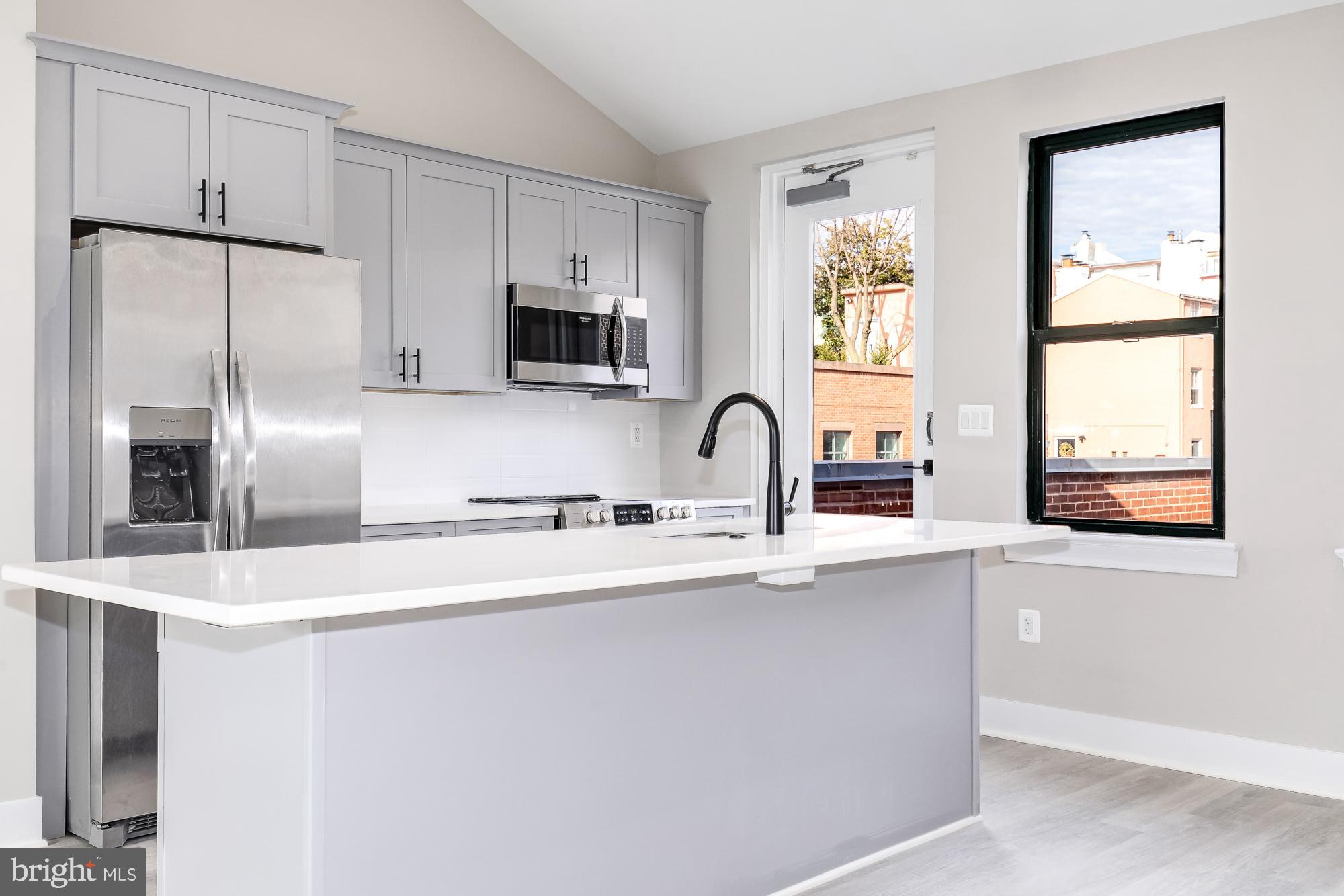 3325 M Street Northwest, Unit TWO Washington, DC 20007 - Photo 4 of 33 a kitchen with stainless steel appliances a sink a refrigerator and a window