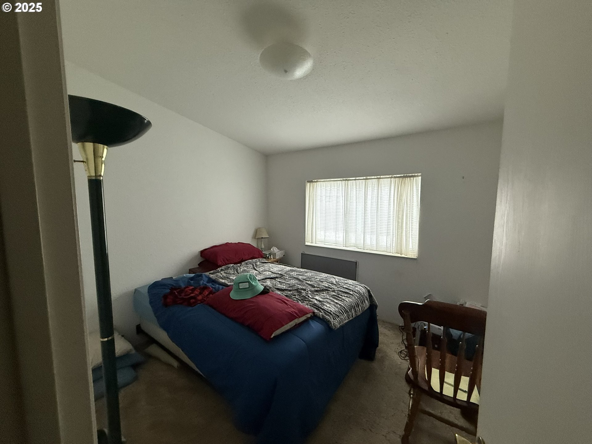 100 River Bend Road, Unit 74 Reedsport, OR 97467 - Photo 13 of 22 a bedroom with a bed and a window