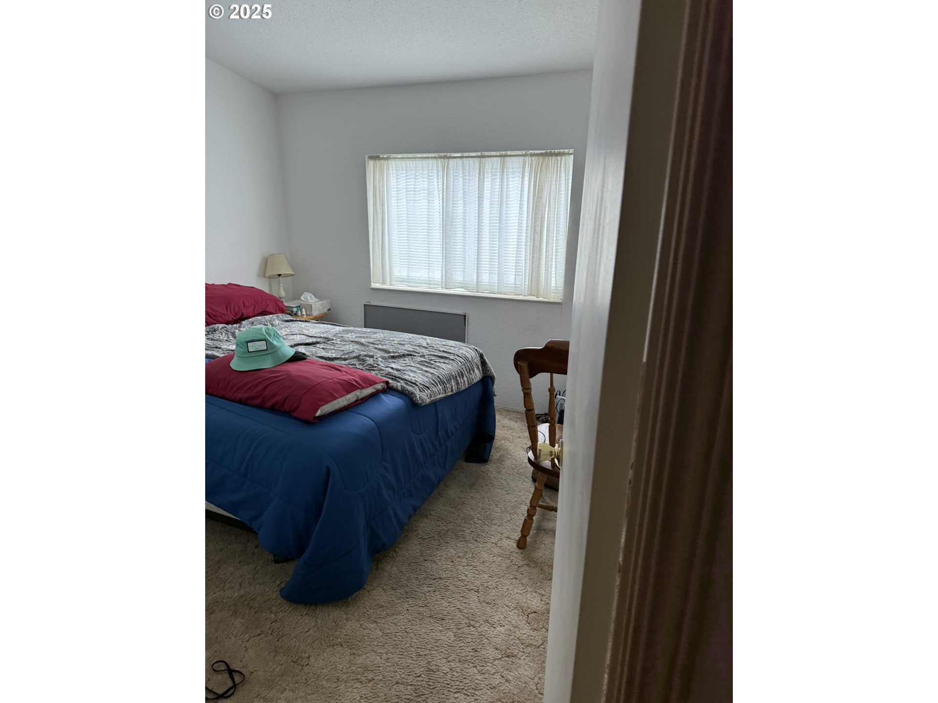 100 River Bend Road, Unit 74 Reedsport, OR 97467 - Photo 18 of 22 a bedroom with a bed and a window