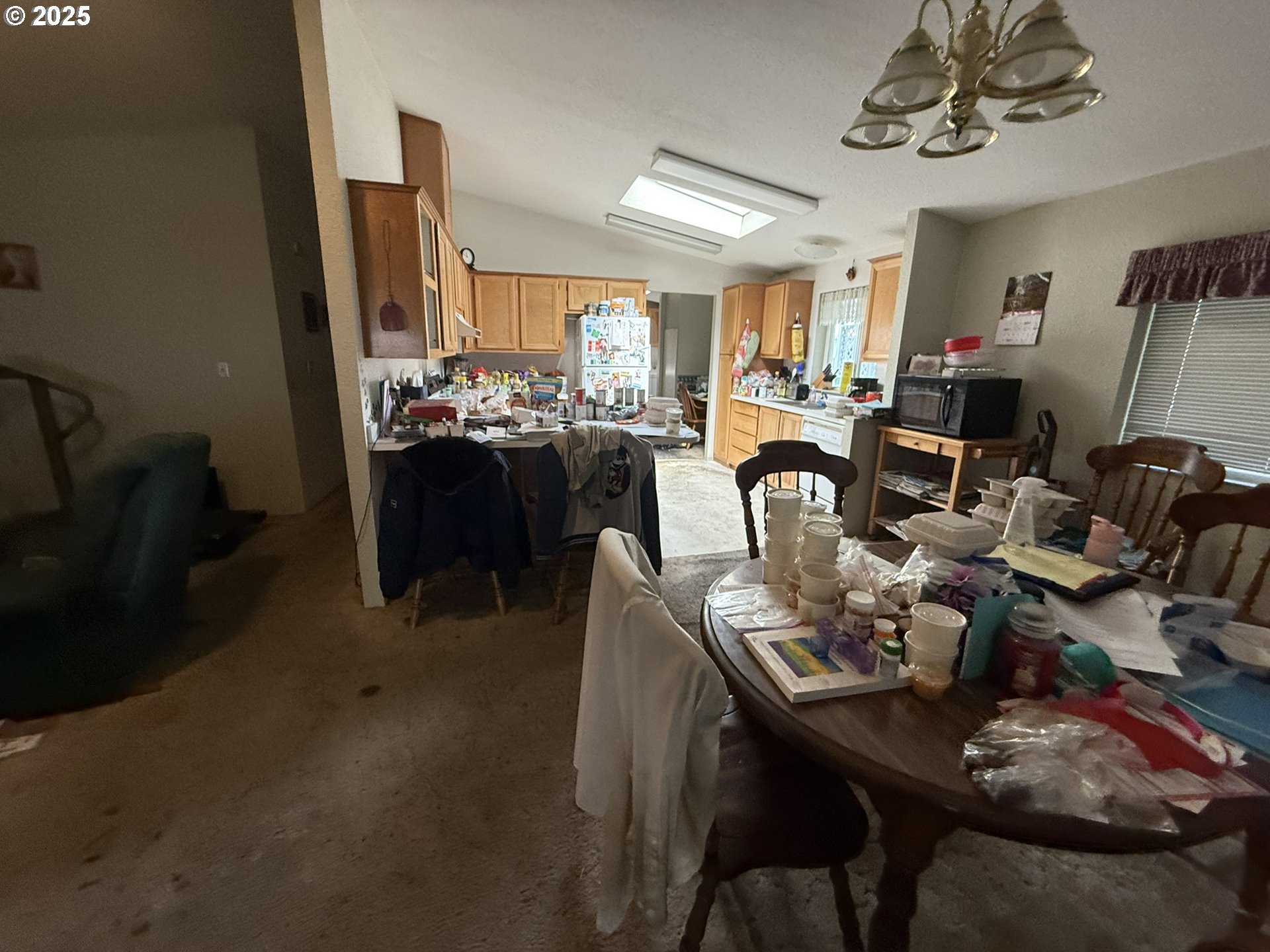 100 River Bend Road, Unit 74 Reedsport, OR 97467 - Photo 7 of 22 a view of a dining room with furniture and a chandelier